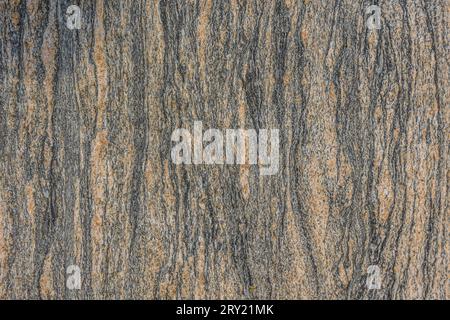Pattern background of granite stone. Vertical lines from a brown stone surface. Structures become visible through dark colors. Natural material Stock Photo