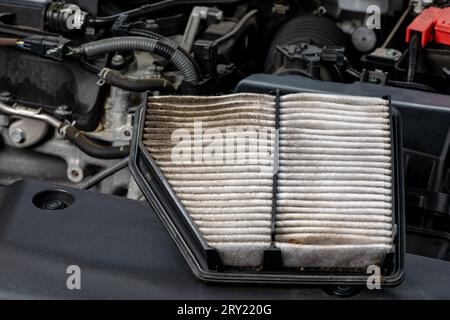 Dirty air filter on vehicle engine. Automotive repair, maintenance, service and fuel mileage concept Stock Photo