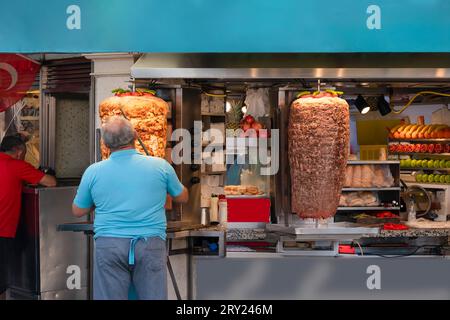 Doner chef making chicken and meat doner in a doner shop. Stock Photo