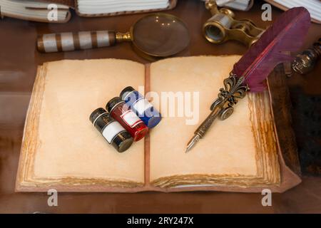 Writing and writing tools in ancient times with ink, feather pen and old notebook. Stock Photo