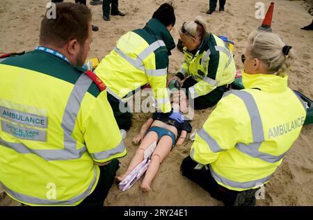 An ambulance crew practice their lifesaving skills on a dummy of a ...