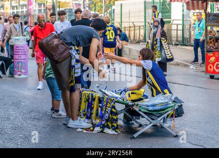 Istanbul, Turkey - September 17, 2023: Street vendors selling football team flags and other items to fans before a football match Stock Photo