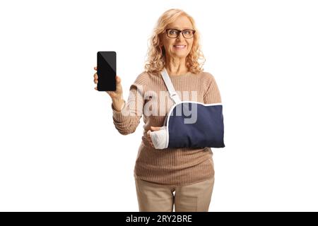 Woman with an arm injury wearing a sling and showing a smartphone isolated on white background Stock Photo