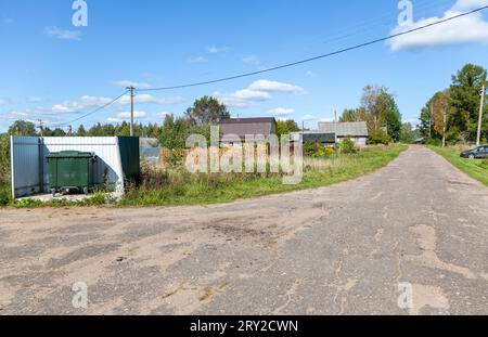 Green plastic garbage container at the outdoors in village in sunny summer day Stock Photo