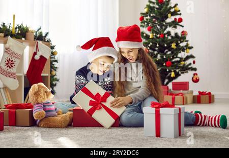 Christmas Family Open Lighting Present Gift Box Under Xmas Tree Happy  Mother Father Children Stock Photo - Download Image Now - iStock