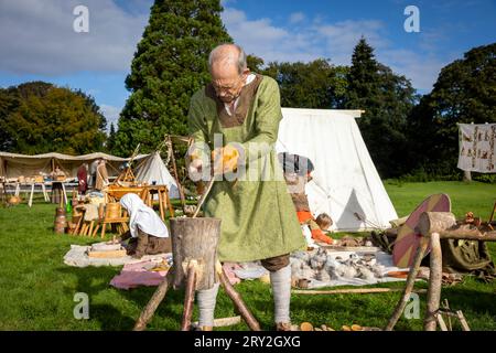 Viking woodsman using an axe celebrating 1100 years of the ancient “cyty” of Thelwall Stock Photo