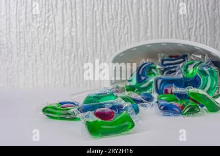 Laundry capsules and plastic containers isolated on white background. High quality photo Stock Photo