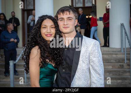 In a close-up prom shot, a multiracial couple strikes a poised and stylish pose, radiating confidence and unit Stock Photo