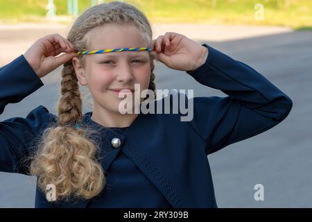 Schoolgirl holds hand on heart! patriot, proud girl,The concept of pride. The concept of pride than anything, patriotism . National colors of Ukraine, Stock Photo