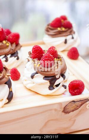 Mini cakes with whipped cream, chocolate, meringue and fresh ...