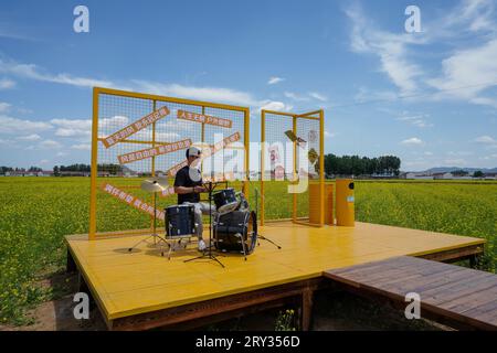 Zunhua City, China - May 13, 2023: Tourists playing drums in the park, North China Stock Photo