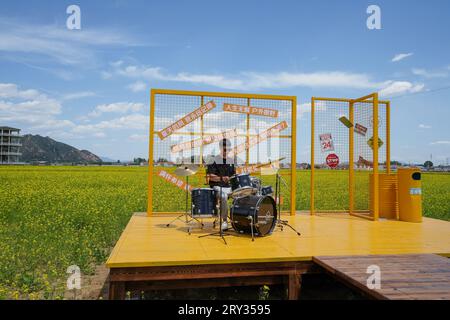Zunhua City, China - May 13, 2023: Tourists playing drums in the park, North China Stock Photo