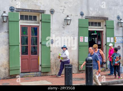 NEW ORLEANS, LA, USA - APRIL 23, 2023: Tourists walk past the famous Tropical Isle bar on Bourbon Street in the French Quarter Stock Photo