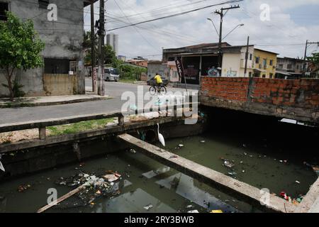 A local ride bicycle past garbage floats on the waters of the Jos Leal Martins canal at the Terra Firma neighbourhood outskirts of Belm on 28 September 2023 in Brazil. The city of Belm, which will be the future host of the 30th UN Conference (COP 30) on climate change, will discuss environmental preservation in 2025. The Trata Brasil Institute, specialised in basic sanitation and water protection research, the city of Belm, has one of the worst sanitation rates in Brazil, with a sewage system available to only 17.1% of the population.(Photo by Paulo Amorim/Sipa USA) Stock Photo