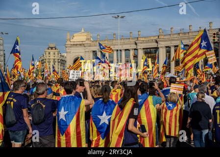 Barcelona, Catalonia, Spain - September 11, 2023: People participating and waving estelada flags in the demonstration for the independence of the Nati Stock Photo