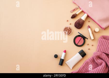 Cosmetic products, make-up with cloth and accessories on color background. Stock Photo