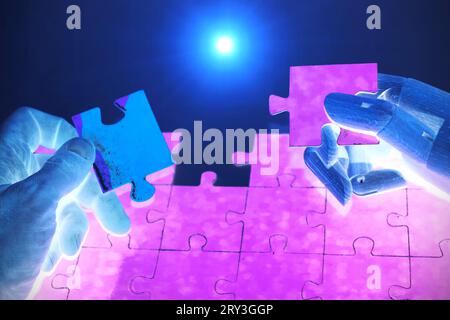 Close-up Of Robot And Human Hand Holding Jigsaw Puzzle Stock Photo