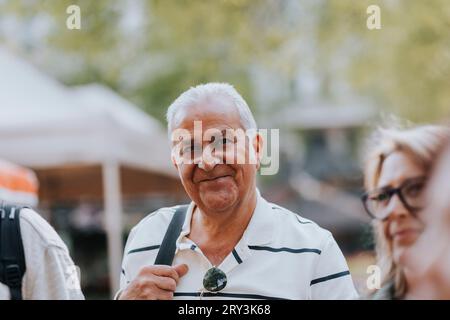 Portrait of smiling senior man with friends Stock Photo
