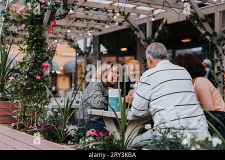 Happy male and female senior friends having fun sitting at restaurant Stock Photo