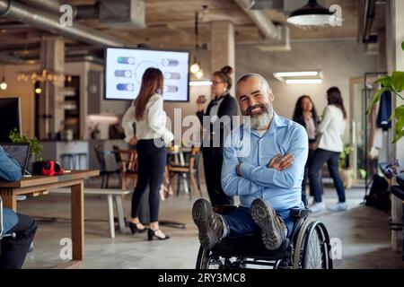 Portrait of happy bearded businessman with disability on wheelchair at office Stock Photo