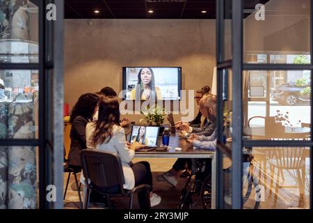 Multiracial business team discussing through virtual meeting at creative office Stock Photo