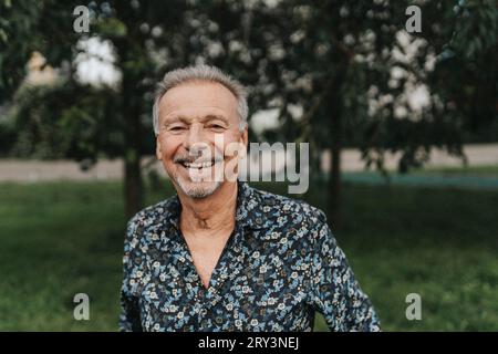 Portrait of happy senior man at park Stock Photo