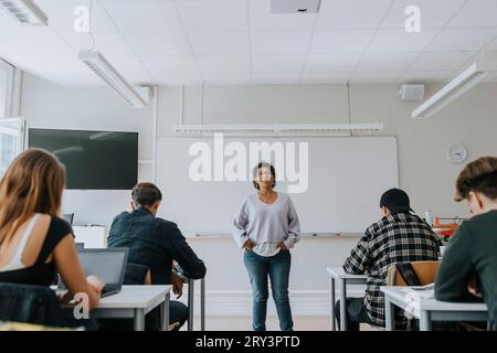Portrait of female teacher and students in classroom Stock Photo - Alamy