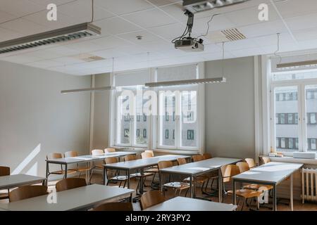 Empty chairs and desks in classroom at school Stock Photo