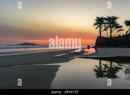 Red sky dawn reflections on Burrow Beach caused by saharan dust in the air Stock Photo