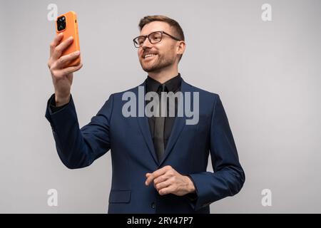 Successful business man with smartphone. Video online chat with customers, trader talking to client  Stock Photo