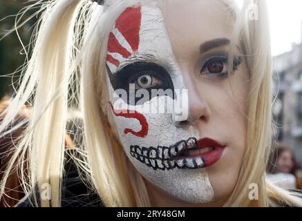 October 27, 2018, Kiev, Ukraine: A young blonde woman wearing a zombie costume and makeup on one side of her face of a Zombie, taking part at the ''Zombie Walk Halloween 2018'' in downtown Kiev. Hundreds people marched through the streets in downtown Kiev, on the eve the Halloween celebrations on October 31. (Credit Image: © Serg Glovny/ZUMA Wire) EDITORIAL USAGE ONLY! Not for Commercial USAGE! Stock Photo