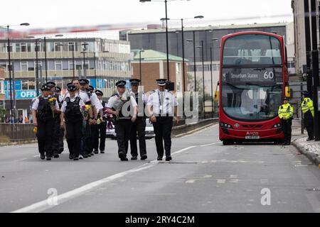 Metropolitan Police including first responders to the scene of the fatal stabbing lay flowers where Elianne Andam, a pupil at the Old Palace of John Whitgift private school, was attacked and killed at 8.30am yesterday as she got off the bus in Croydon, South London, Croydon, London, UK 28th September 2023 Credit: Jeff Gilbert/Alamy Live News Stock Photo