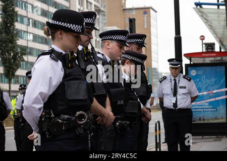 Metropolitan Police including first responders to the scene of the fatal stabbing lay flowers where Elianne Andam, a pupil at the Old Palace of John Whitgift private school, was attacked and killed at 8.30am yesterday as she got off the bus in Croydon, South London, Croydon, London, UK 28th September 2023 Credit: Jeff Gilbert/Alamy Live News Stock Photo