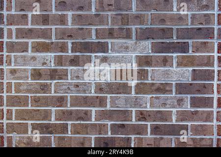 Brown brick wall texture with white mortar joints, architectural background. Stock Photo