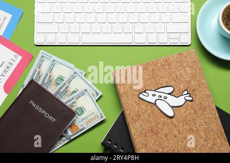 Flat lay composition with passport, dollars and keyboard on green table. Business trip Stock Photo