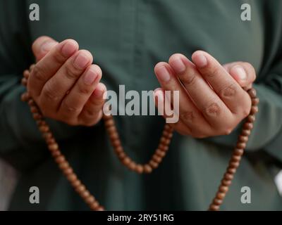 Front view of Muslim women raising hands in prayer Stock Photo