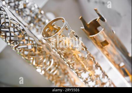 Metal pipes processed with laser cutting machine in shop Stock Photo