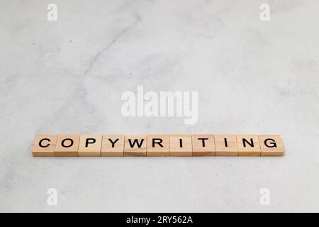 Top view of Copywriting word on wooden cube letter block on white background. Business concept Stock Photo