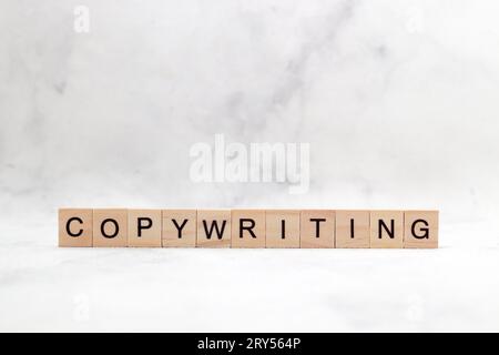 Top view of Copywriting word on wooden cube letter block on white background. Business concept Stock Photo
