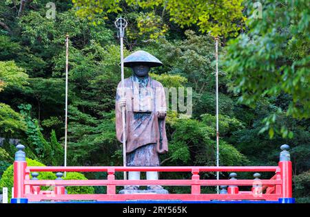 Shodoshima, Japan - September 25, 2023: Statue of wandering pilgrim in traditional robes and hat at outdoor temple Stock Photo