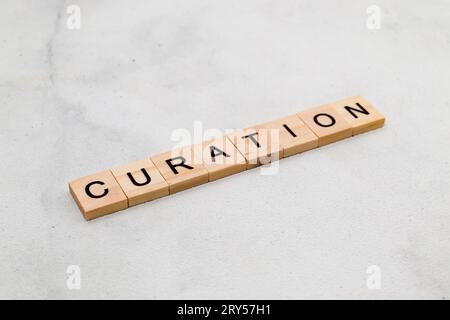 Top view of Curation word on wooden cube letter block on white background. Business concept Stock Photo