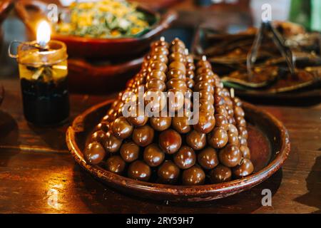 Sate Telur Puyuh or Brown Quail Egg Satay on the rounded clay plate. Indonesian traditional food. Stock Photo