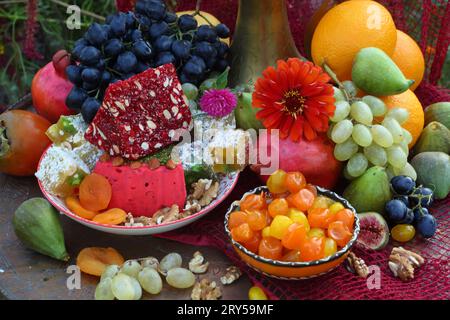 Oriental sweets with a copper jug on a red background Stock Photo