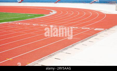 Red running track in outdoor sports stadium Stock Photo