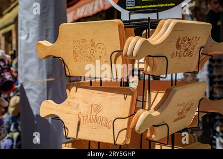 Strasbourg, France - May 31 2023: Wooden cutting boards with gingerbread man and pretzels traditional Alsatian designs on display at a souvenir store Stock Photo