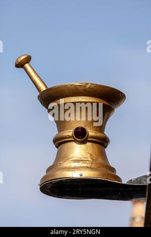 Traditional mortar and pestle sign on a building, indicating a dispensing pharmacy, Crail, Fife Stock Photo