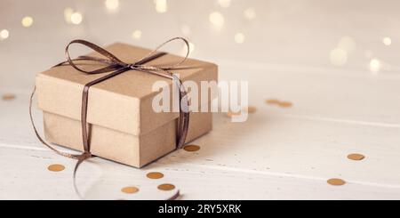 Christmas gift box on white wooden table. Front view. Stock Photo