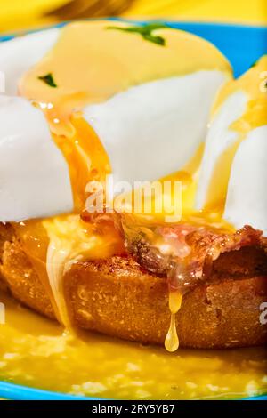 Close-up of poached eggs with liquid yolk and bacon on toasted bun. Breakfast, food. Pop art Stock Photo