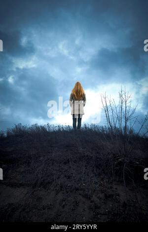 woman standing on the top of a ridge Stock Photo