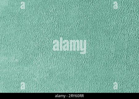 Terry cloth, turquoise towel texture background. Soft fluffy textile bath or beach towel material. Top view, close up. Stock Photo